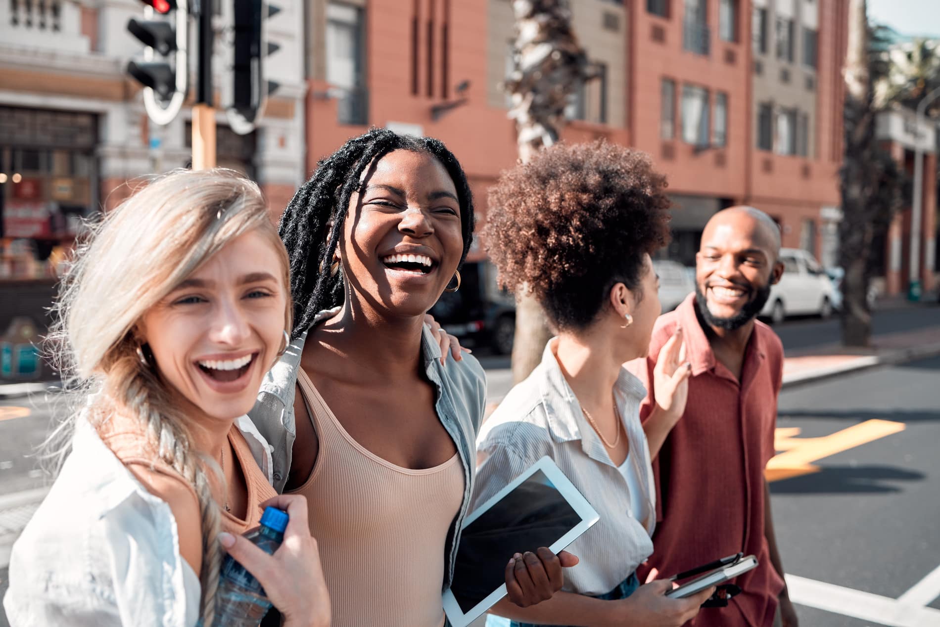 A Group of diverse students having fun outdoors in the city on a sunny summer day. Portrait of young people or friends laughing and smiling together in an urban town while walking to campus People enjoying the sun after general dentistry in Salt LAke