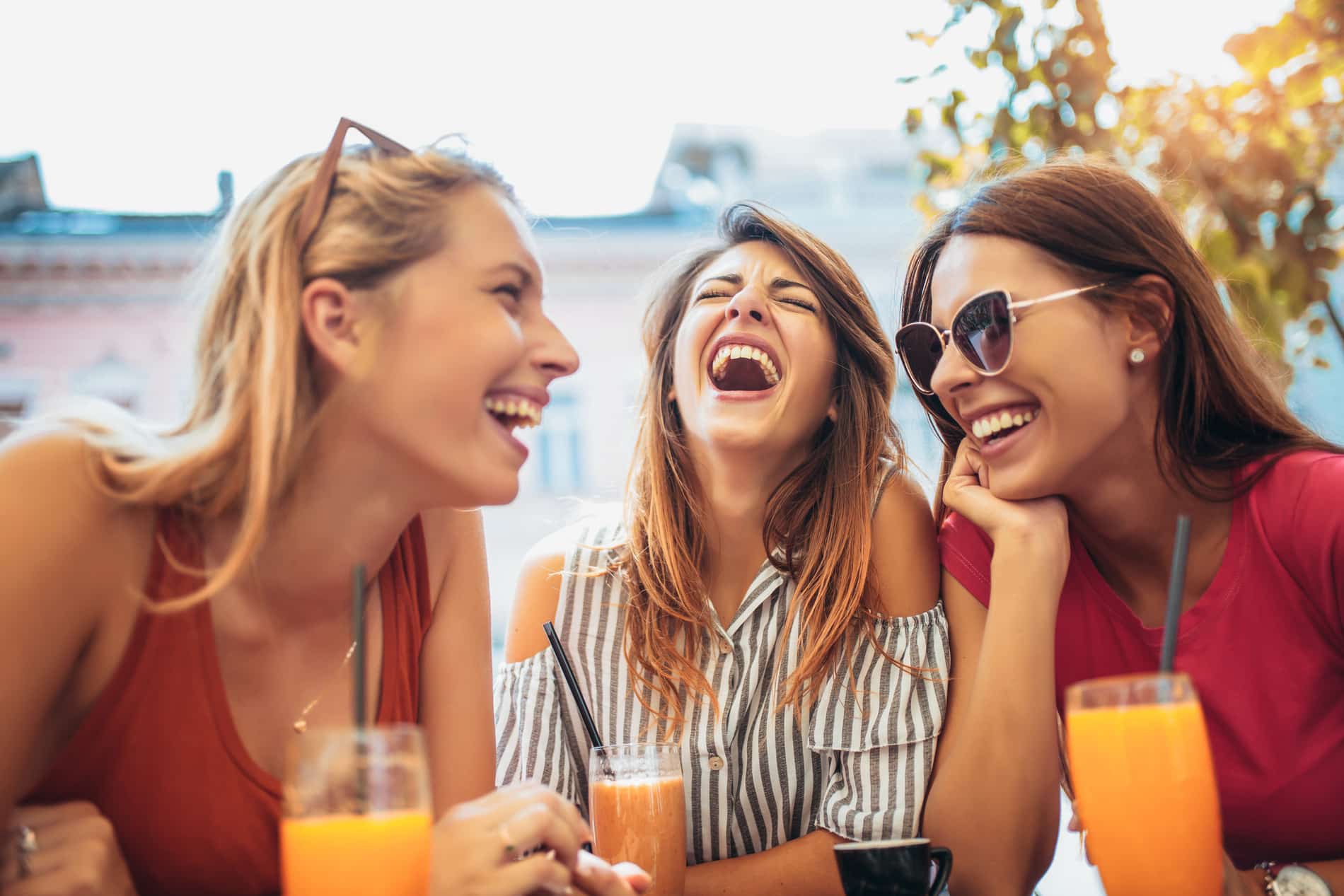 AdobeStock_229924110 v2 Friends laughing with All-on-4 dental implants at Renovo Prosthodontics