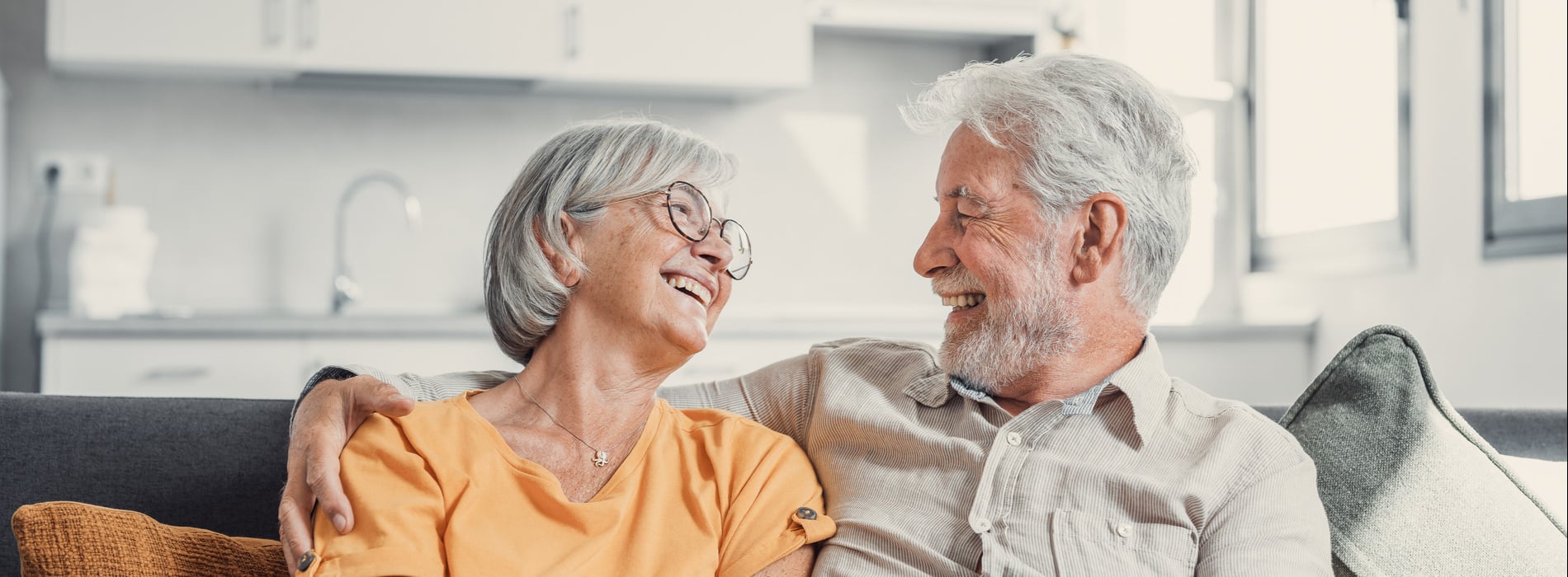 AdobeStock_709687572 v2 man and woman smiling together after getting dental implants in Salt Lake City UT