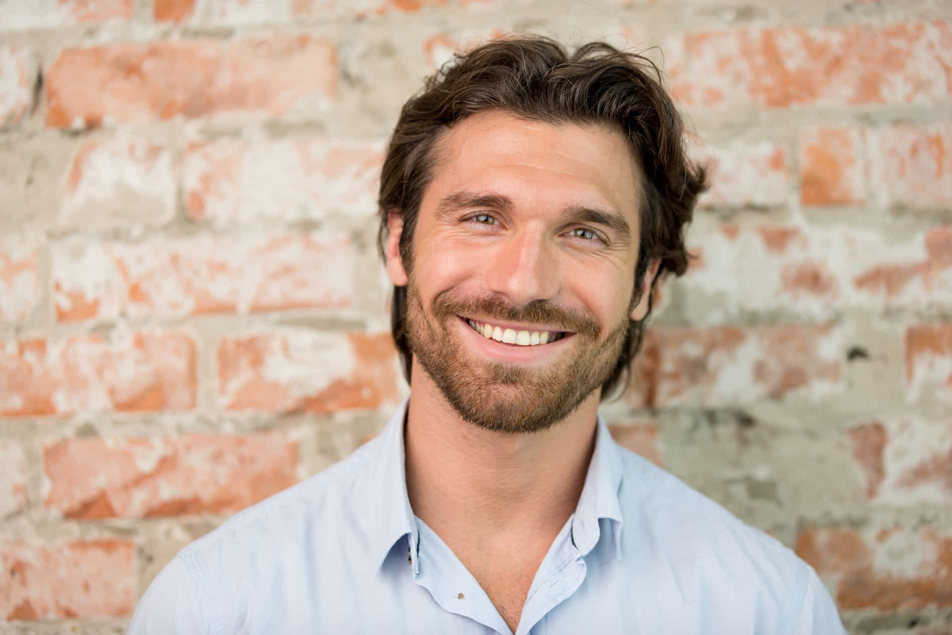 AdobeStock_217449874 v2 Man showing off his restored smile with on day dental implants in Utah