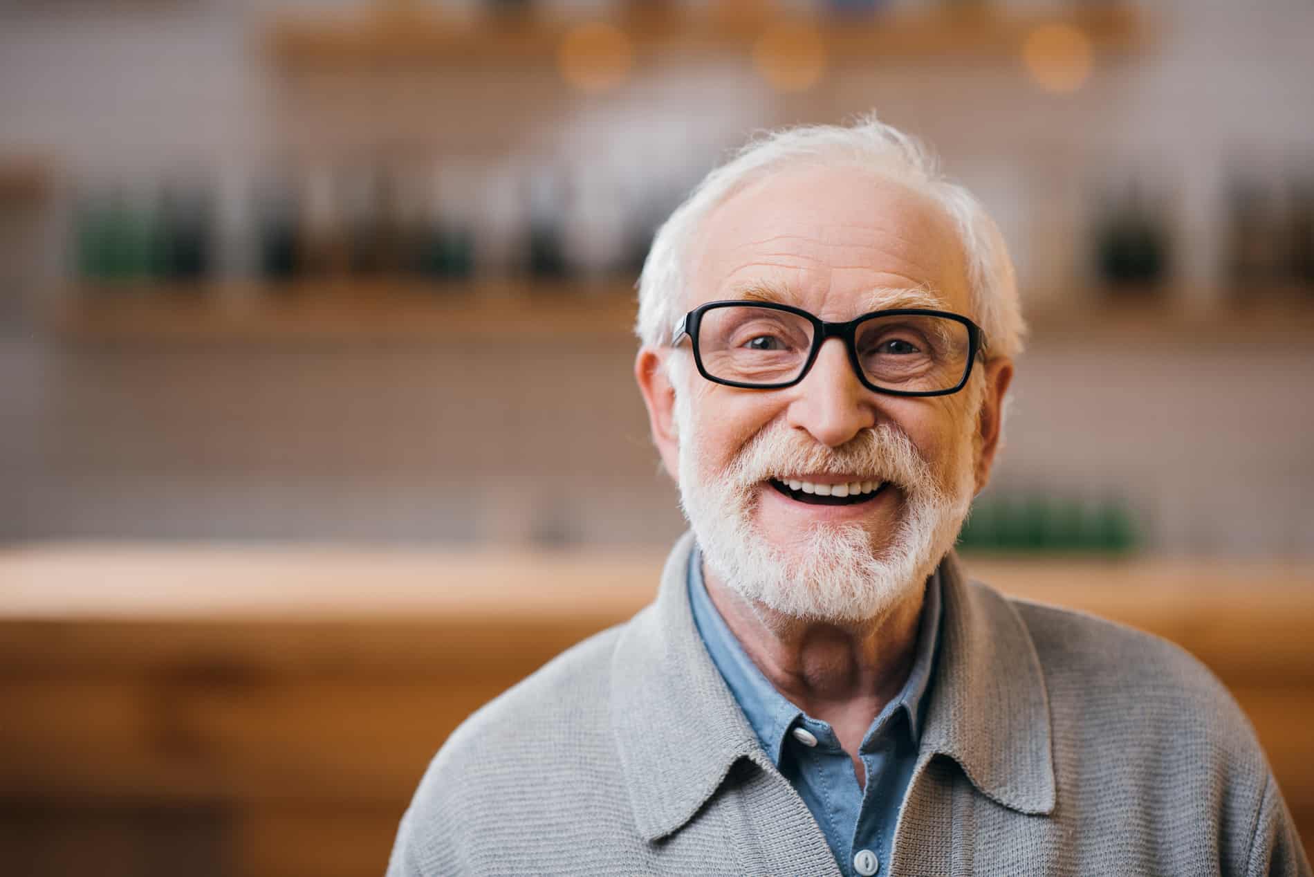 Man showing off his new smile with full dentures from Dr. McWhorter