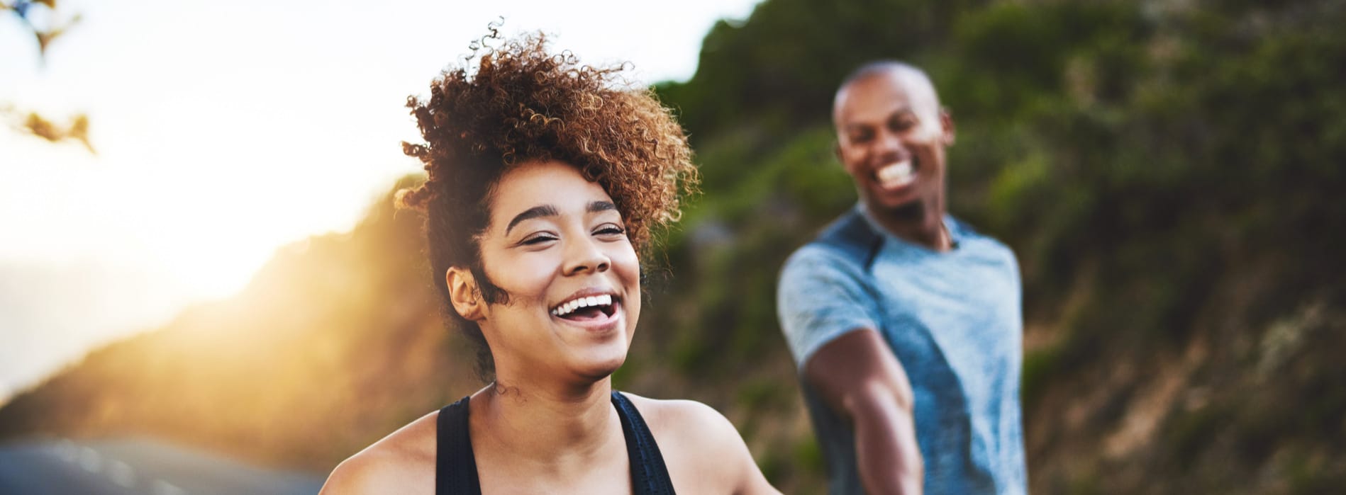 Woman runs with her husband after a successful full-mouth rehabilitation in SLC UT